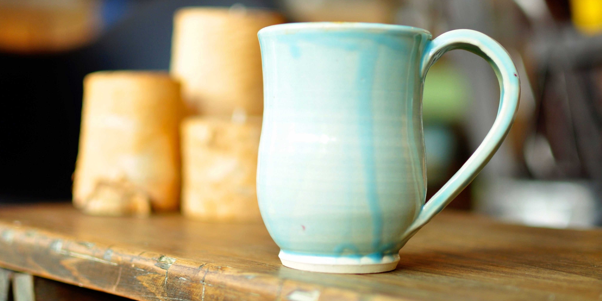 Light blue, ceramic mug on work desk