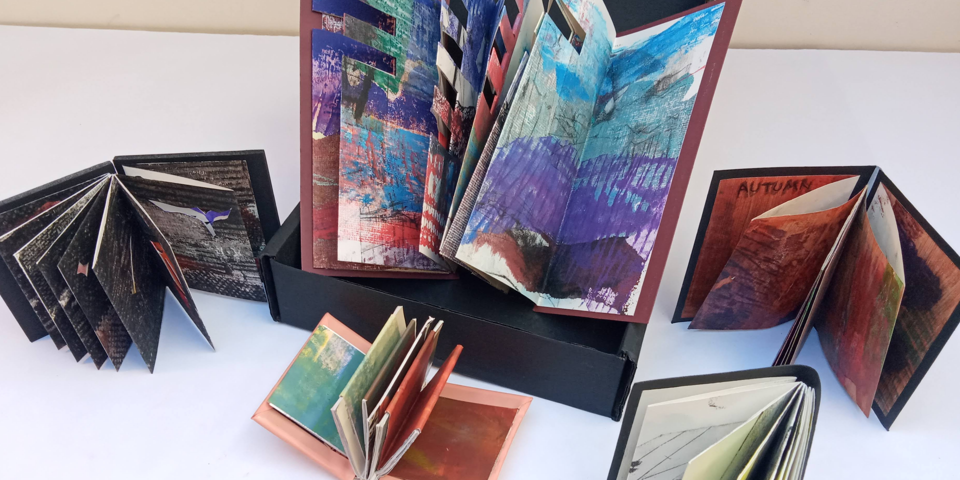A selection of handmade books with colourful abstract pages