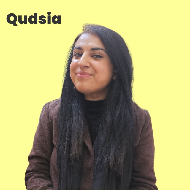 Yellow square with picture of Qudsia, South Asian female, long dark hair, brown coat